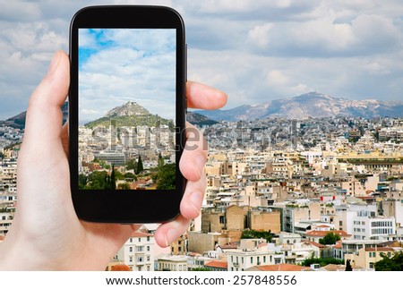 travel concept - tourist taking photo of Athens city skyline on mobile gadget, Greece