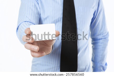 Man in shirt and tie holds a white business card in hand, no face
