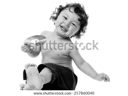 Baby playing with disk,isolated ona white background.