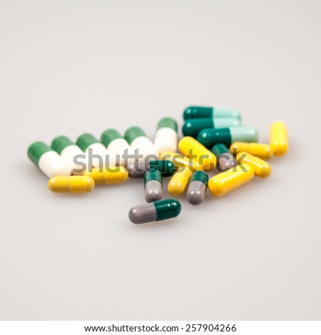 Composition with colorful pills and light grey background