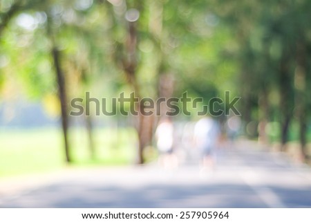 Blurred background of people activities in park with bokeh, spring and summer season