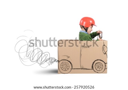 Creative baby plays with his cardboard car Royalty-Free Stock Photo #257920526