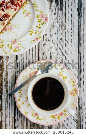 Cranberry cake and coffee cup on wooden background - film effect style pictures