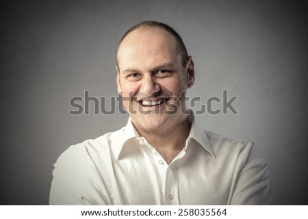 Smiling man  Royalty-Free Stock Photo #258035564