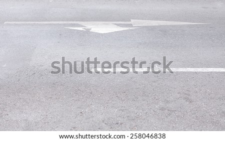arrow symbol on a black asphalt road surface