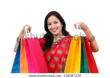 Traditional Indian woman holding shopping bags 