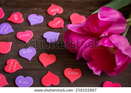 bouquet of flowers lying next to hearts