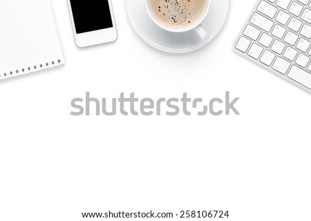Office desk table with computer, supplies and coffee cup. Isolated on white background. Top view with copy space