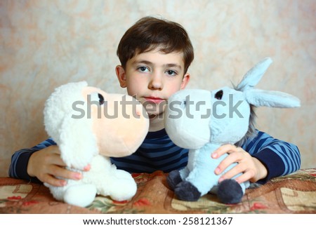 preteen handsome boy with toys