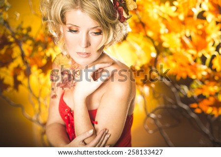 Magic gold autumn blonde girl portrait in leafs