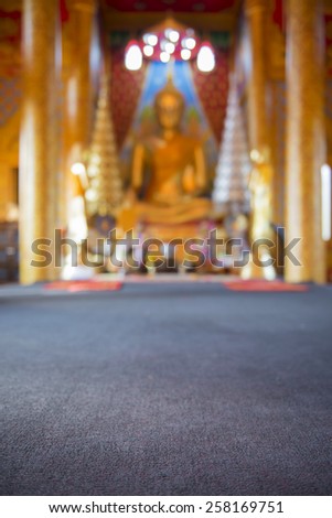 Golden Buddha statue in temple blurred background ,Thailand