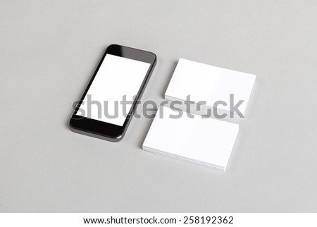 Photo of business cards and smartphone. Mock-up for branding identity. For graphic designers presentations and portfolios