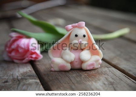 Easter rabbit. Pink tulips. Wooden background. Spring. 