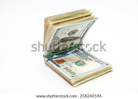 US Dollars tied with a rubber band isolated, white background