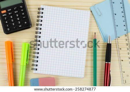 Office tools with blank notebook on wooden table