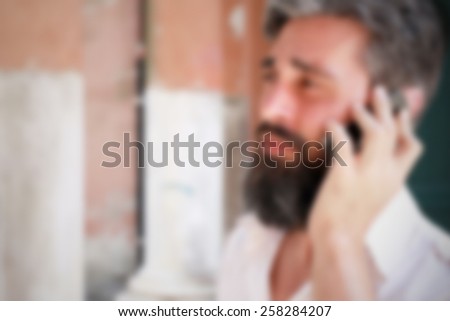 Bearded man during a phone call. Intentionally blurred editing post production.