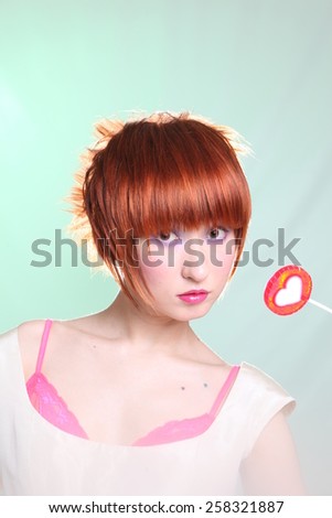 Red had girl with lollipop on light blue background