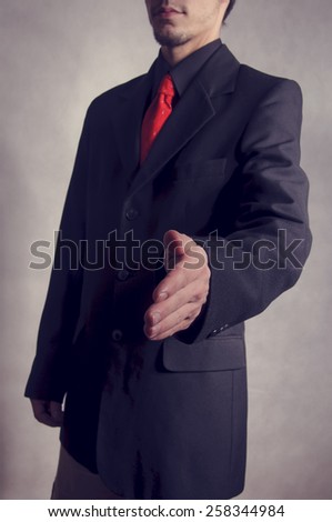 businessman extending hand to shake