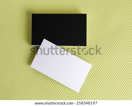 Blank black and white business cards on a green background. Template for ID.  Isolated with clipping path. Top view.