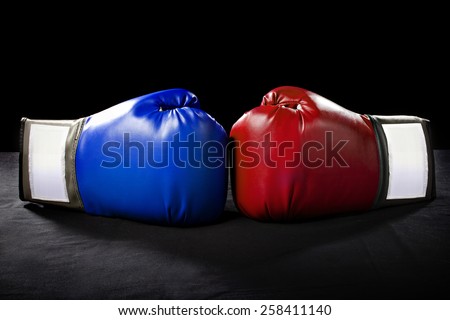 boxing gloves or martial arts gear on a black background Royalty-Free Stock Photo #258411140