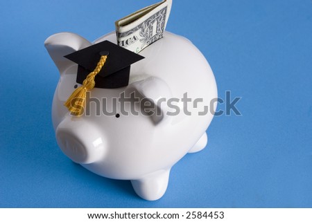 Piggy bank with a graduation cap with dollar bill Royalty-Free Stock Photo #2584453