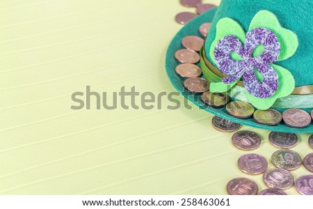 St patricks day hat and gold coins on table