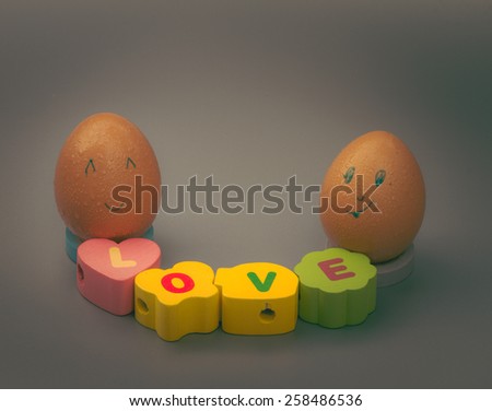 love concept : two smile eggs with letter love isolated on white background