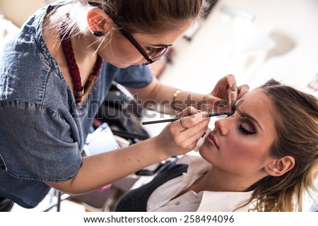Make-up artist work in her studio. Royalty-Free Stock Photo #258494096