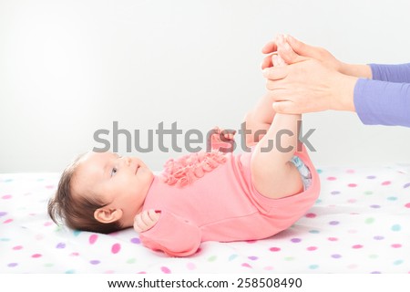 Mom holding her little daughter's feet. Copy space above