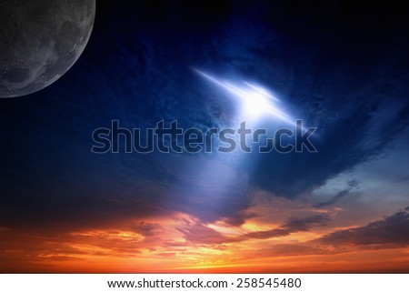 Abstract fantastic background - ufo with bright spotlight, glowing red sunset, moon in dark blue sky. Elements of this image furnished by NASA nasa.gov