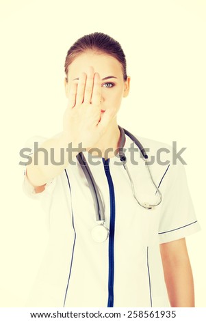Beautiful female doctor give you reject gesture.
