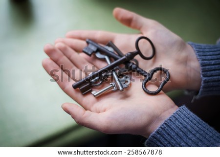 hand holding an old metal key 