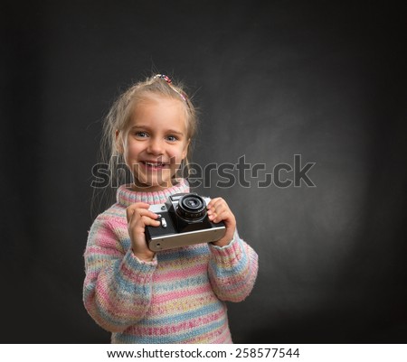 Little girl with retro camera