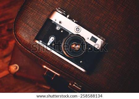 Vintage camera on old suitcase
