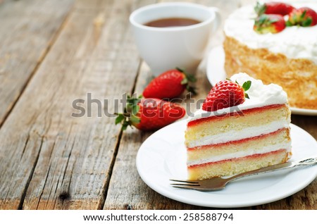 cake with cream and strawberries on a dark wood background. tinting. selective focus Royalty-Free Stock Photo #258588794