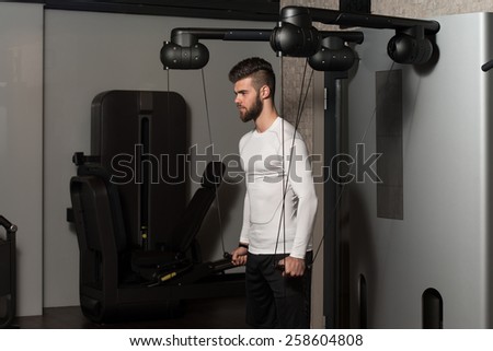 Handsome Man Is Working On His Shoulders With Cable Crossover In A Modern Gym