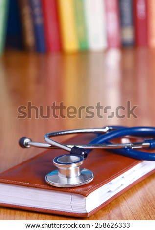 Stethoscope on book with leather cover 