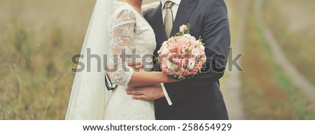 Newlywed couple happy together at field.  Royalty-Free Stock Photo #258654929