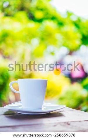 White coffee cup on wooden tables and outdoor garden background - Processing color effect style pictures