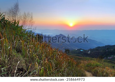 The sunset of Doi Pha Tang viewpoint at Chiang Rai province in Thailand is a beautiful location and very popular for photographers and tourists