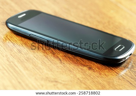 Smartphone on wooden borad.