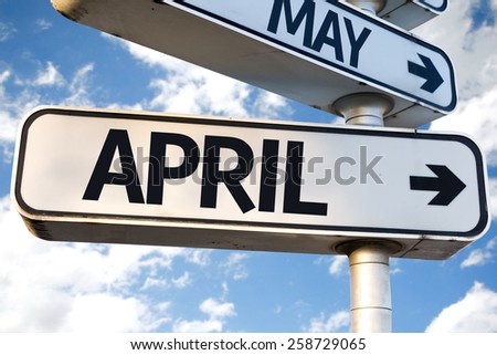 April direction sign on sky background