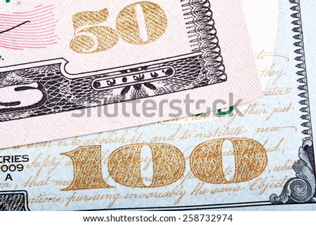 Stacked photo. Detail of new design of 100 and 50 dollars (banknote) bills.