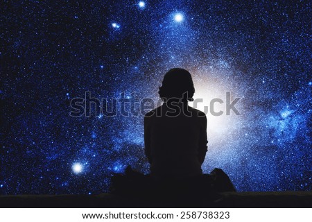 Girl watching the space. Stars are digital illustration. Royalty-Free Stock Photo #258738323