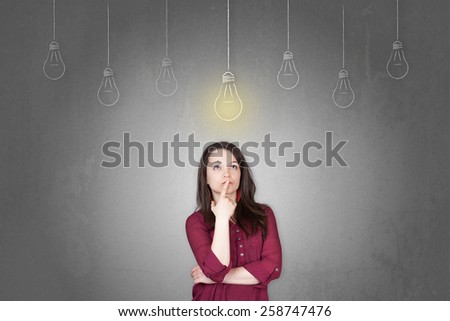 Beautiful young and pretty woman thinking in front of light idea bulbs concept