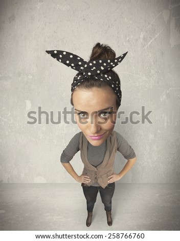 Funny girl with big head, grunge wall background