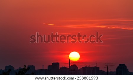 Dramatic sunset with bright Sun disk over skyline