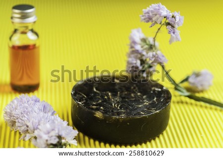 tar oil soap on yellow background Royalty-Free Stock Photo #258810629