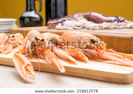 prawns and shrimp raw ready to be cooked on a wooden table in the kitchen