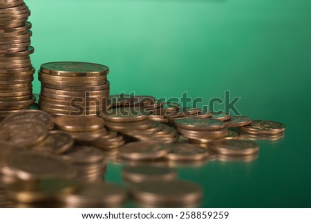 Golden columns of coins on green background. Copy space. Banking. Go to Bank